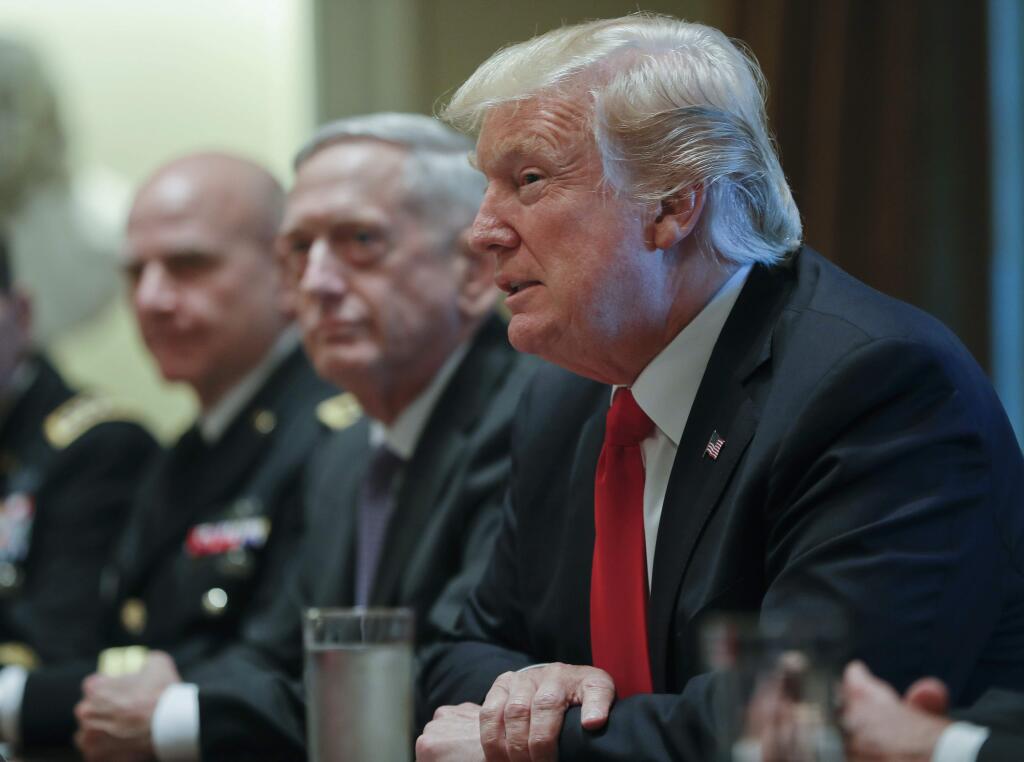 President Donald Trump, right, speaks during a briefing with senior military leaders in the Cabinet Room of the White House in Washington, Thursday, Oct. 5, 2017, with National Security Adviser H.R. McMaster, left, and Defense Secretary Jim Mattis, center. (AP Photo/Pablo Martinez Monsivais)