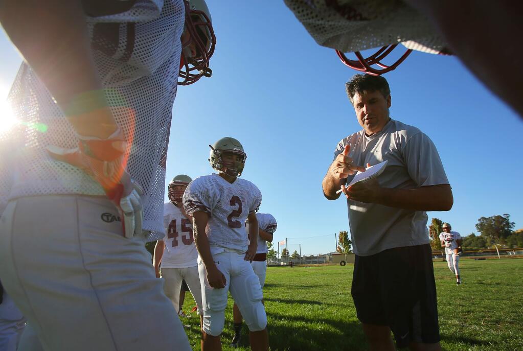 Cardinal Newman head football coach Paul Cronin gives directions to his offense during practice in Santa Rosa on Monday, August 8, 2016. (Christopher Chung / The Press Democrat)