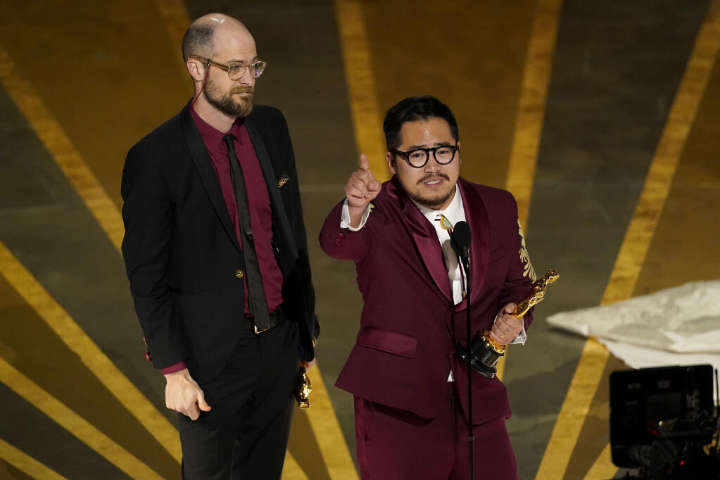 Daniel Scheinert, left, and Daniel Kwan accept the award for best original screenplay for "Everything Everywhere All at Once" at the Oscars on Sunday, March 12, 2023, at the Dolby Theatre in Los Angeles. (AP Photo/Chris Pizzello)