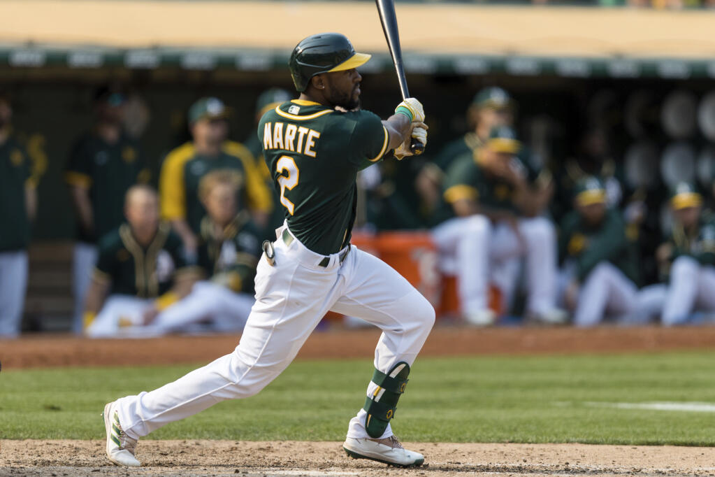 The Oakland Athletics’ Starling Marte hits an RBI for a walk-off win against the Houston Astros in the ninth inning in Oakland on Saturday, Sept. 25, 2021. The Athletics won 2-1. (John Hefti / ASSOCIATED PRESS)