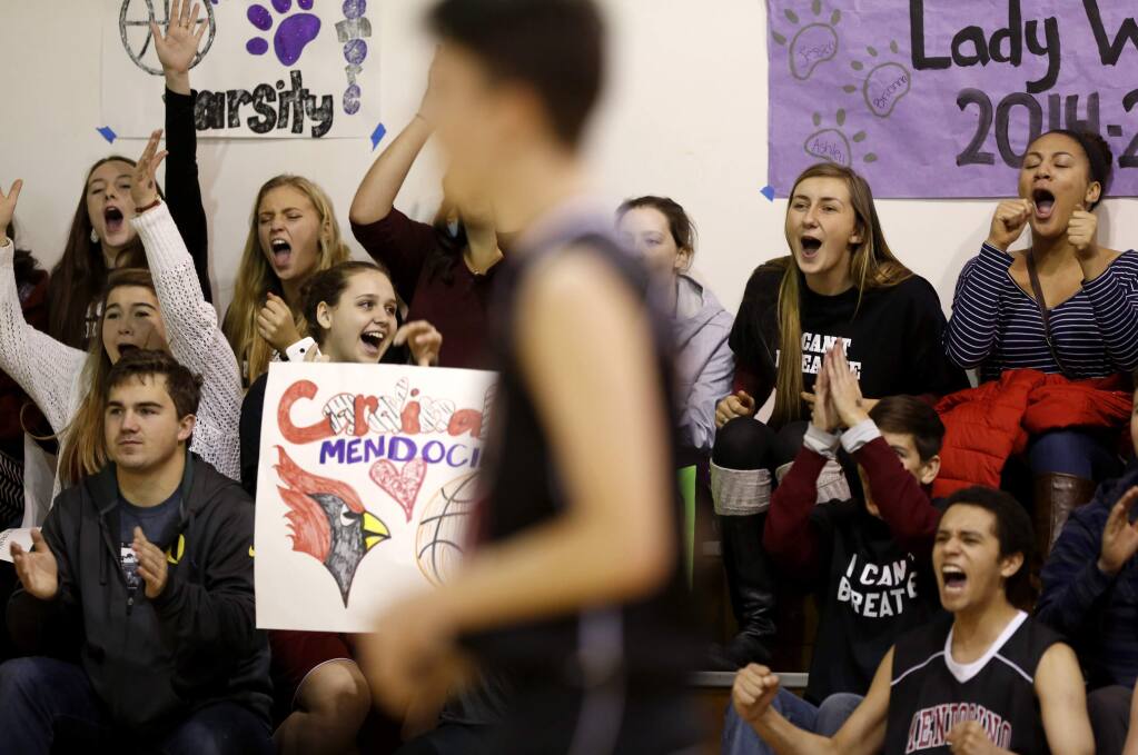 Members of the Mendocino High girls' basketball team and their classmates watch the Mendocino High boys' team compete during a basketball tournament at Fort Bragg High School in For Bragg on Monday, December 29, 2014. (BETH SCHLANKER / The Press Democrat)