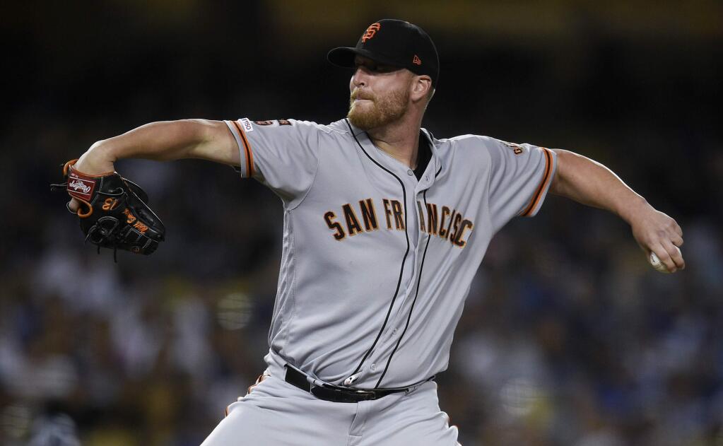 In this Sept. 6, 2019, file photo, San Francisco Giants relief pitcher Will Smith pitches during the ninth inning against the Los Angeles Dodgers in Los Angeles. The Atlanta Braves have bolstered their shaky bullpen by signing left-hander reliever Smith to a three-year, $40 million contract. The free agent deal announced Thursday, Nov. 14, 2019, includes a $13 million option for the 2023 season, with a $1 million buyout. (AP Photo/Kelvin Kuo, File)