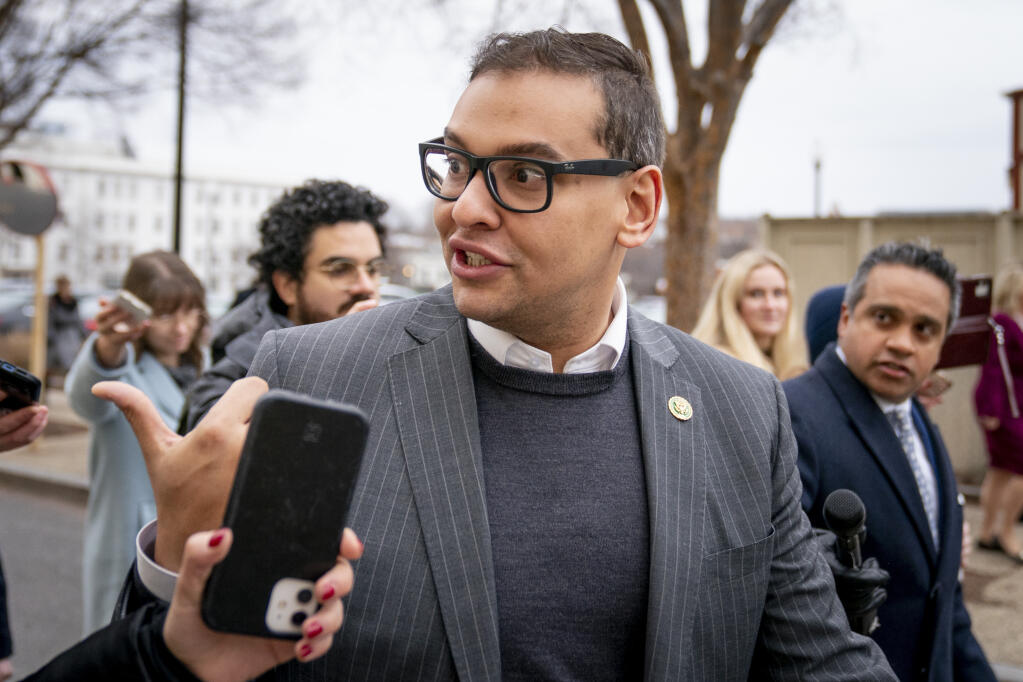 FILE - Rep. George Santos, R-N.Y., leaves a House GOP conference meeting on Capitol Hill in Washington, Jan. 25, 2023.  Santos told colleagues in a closed-door meeting Tuesday that he is temporarily stepping down from his two congressional committees. (AP Photo/Andrew Harnik, File)