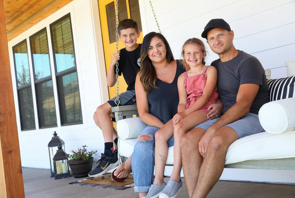 Katrina and Danny Lassen, with their children, Kaiden, 12, and Makenna, 9, have enjoyed the sense of community and bonding they've shared with their neighbors by hanging out on their front porch in the Larkfield Estates subdivision. (Christopher Chung / The Press Democrat)
