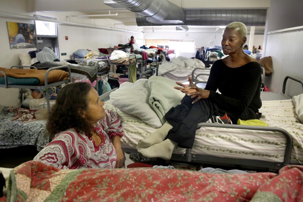Volunteer Jamie Sutton, left, talks with a woman known as Flowers at the COTS Mary Isaak Center in Petaluma, on Tuesday, May 24, 2016. (BETH SCHLANKER/ The Press Democrat)