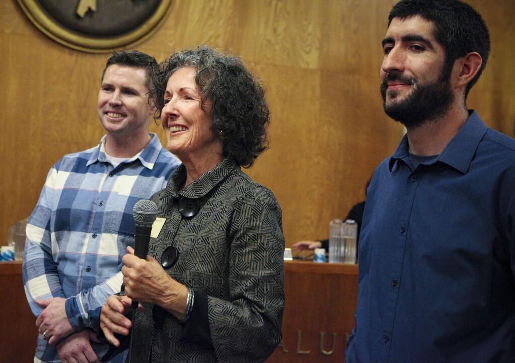 The newly elected mayor of Petaluma gets sworn in with her sons by her side, Max Barrett Cota, 37 (left) and Joe Barrett Cota, 32 (right) on Tuesday, January 7.(CRISSY PASCUAL/ARGUS-COURIER STAFF)