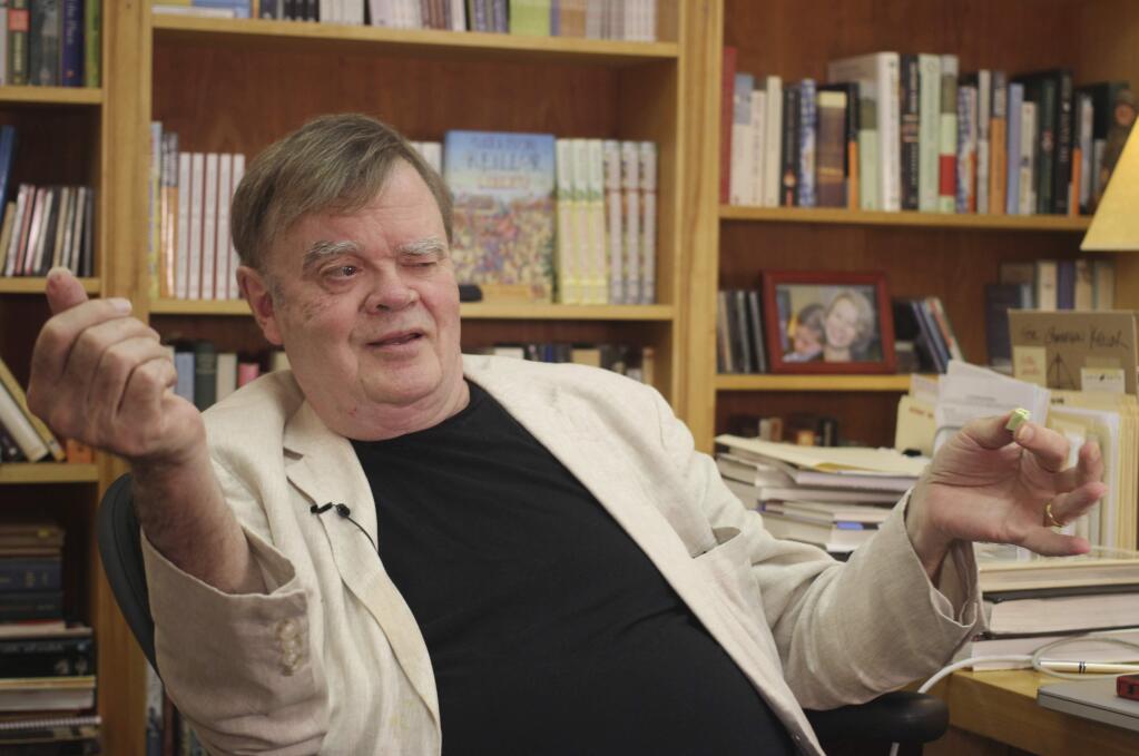 FILE - In this July 26, 2017 file photo, Garrison Keillor, creator and former host of, 'A Prairie Home Companion,' talks at his St. Paul, Minn., office. Keillor said Wednesday, Nov. 29, he's been fired by Minnesota Public Radio over allegations of improper behavior. (AP Photo/Jeff Baenen, File)