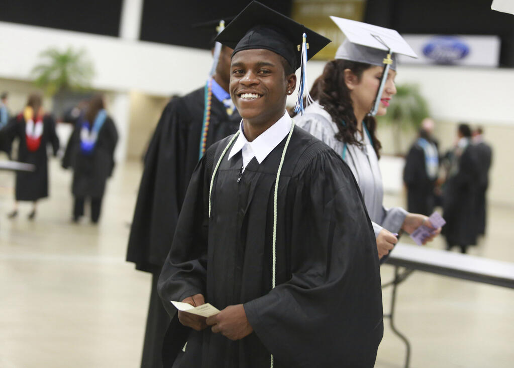 FILE - This May 23, 2016 file photo shows Royal Palm Beach High School student Damon Weaver during his high school graduation in West Palm Beach, Fla.  Weaver who gained national acclaim when he interviewed President Barack Obama at the White House in 2009 has died of natural causes, his family says.  Weaver was 23 when he died May 1, 2021 his sister, Candace Hardy, told the Palm Beach Post.  (Carline Jean/South Florida Sun-Sentinel via AP)
