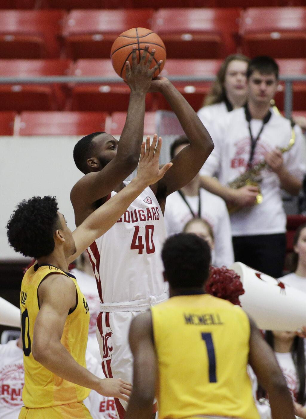 Washington State guard Kwinton Hinson, center, shoots against California forward Justice Sueing, left, during the first half of an NCAA college basketball game in Pullman, Wash., Saturday, Jan. 13, 2018. (AP Photo/Young Kwak)