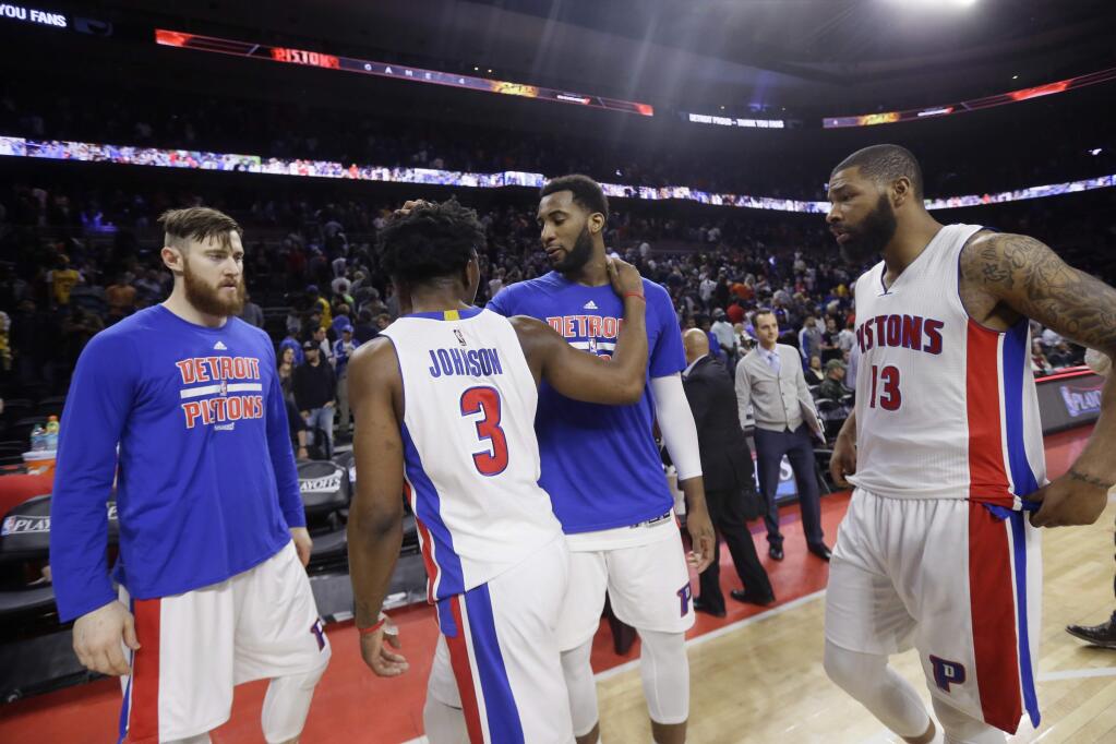 From left, Detroit Pistons center Aron Baynes, forward Stanley Johnson (3), center Andre Drummond and forward Marcus Morris (13) walk off the court after Game 4 of a first-round NBA basketball playoff series against the Cleveland Cavaliers, Sunday, April 24, 2016 in Auburn Hills, Mich. The Cavaliers defeated the Pistons 100-98 and swept the series. (AP Photo/Carlos Osorio)