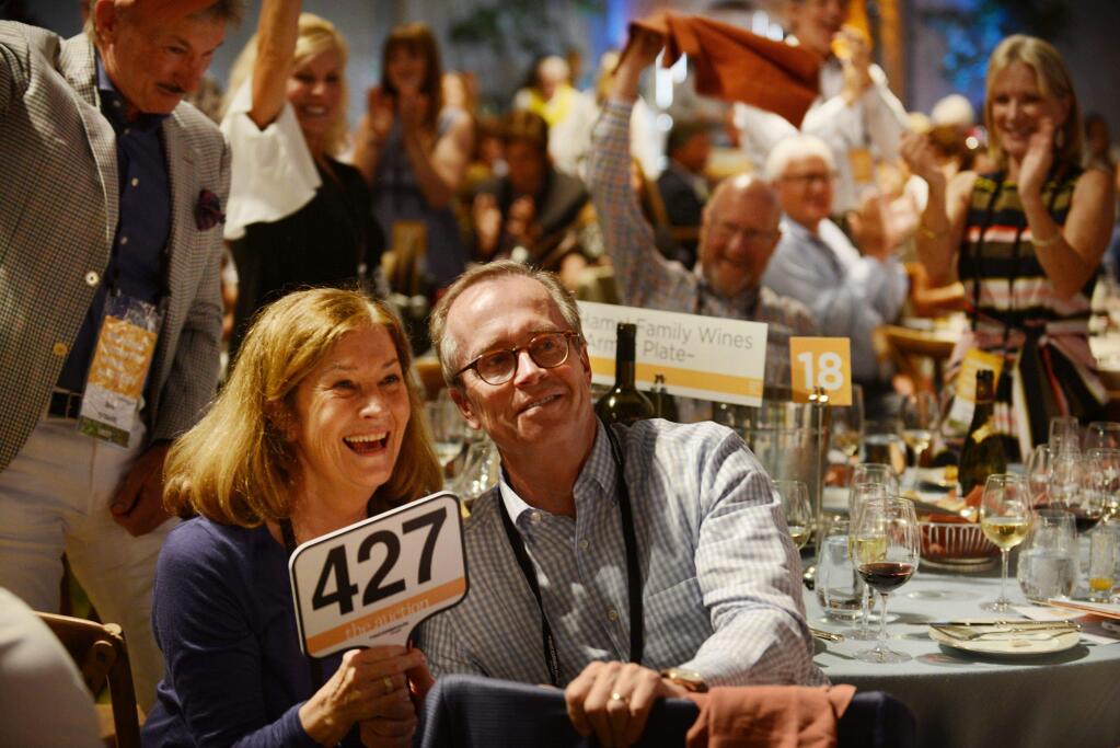 Pamela Hamel, left, and George Hamel Jr. of Hamel Family Wines celebrate after a winning bid in 2017. (Photo: Erik Castro/for The Press Democrat)
