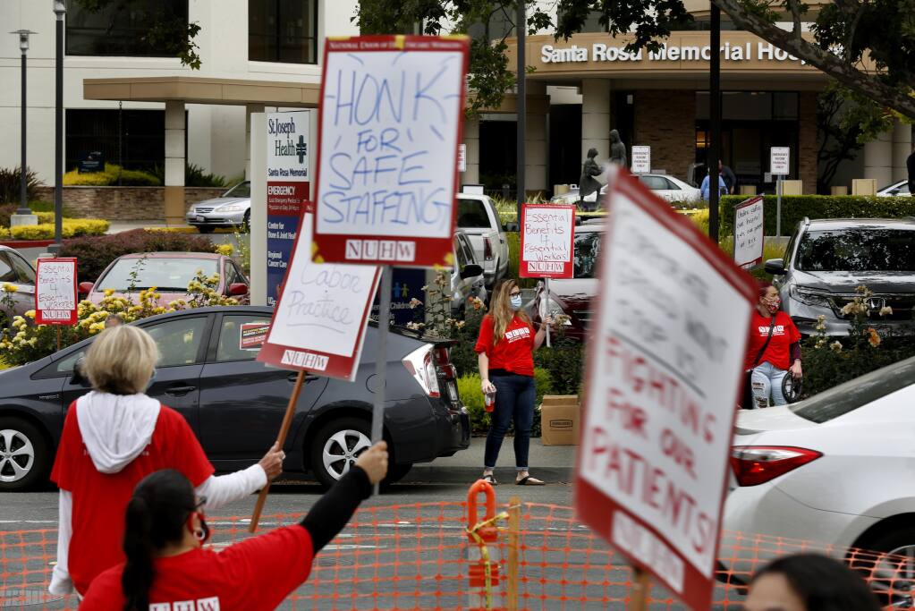 Health care workers from Santa Rosa Memorial Hospital join with members and supporters of the National Union of Healthcare Workers strike outside Santa Rosa Memorial Hospital in Santa Rosa, Calif., on Monday, July 20, 2020. (BETH SCHLANKER / The Press Democrat)