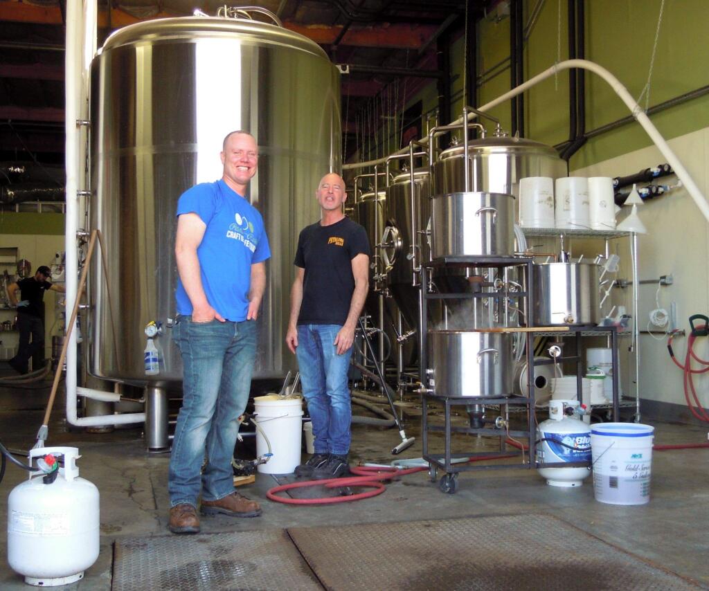 Homebrewer Kevin Larson, left, and JJ Jay, owner of Petaluma Hills Brewery, talk about beer making at the brewery. Larson is participating in the homebrew roots program at Petaluma Hills. HOUSTON PORTER