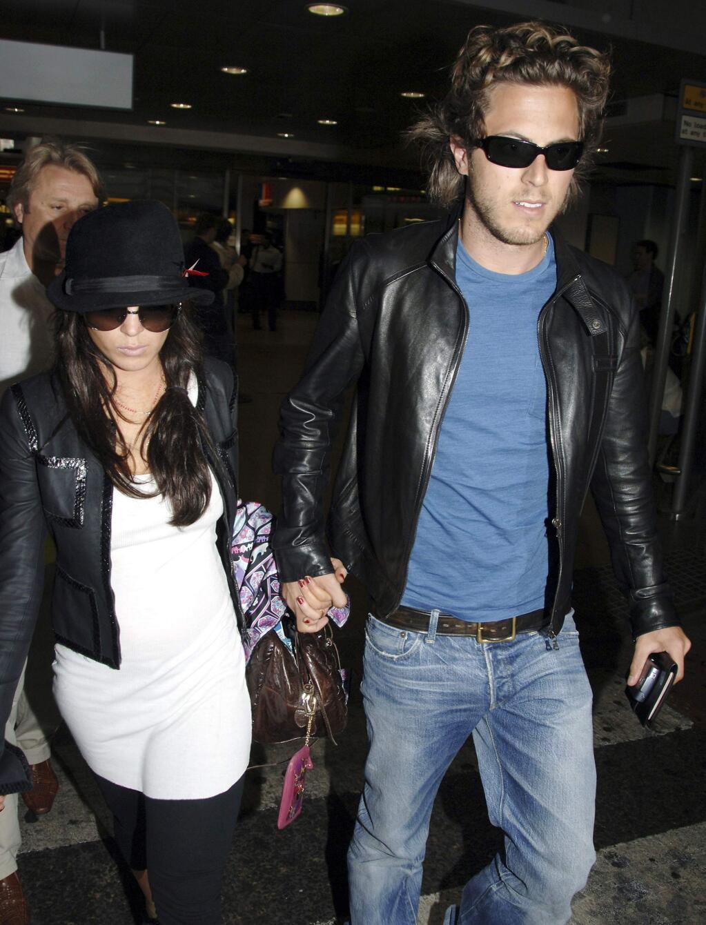 FILE - In this Thursday Sept. 7, 2006, file photo, Hollywood actress Lindsay Lohan, left, and boyfriend, Harry Morton arrive at London's Heathrow Airport from Venice, Italy. Harry Morton, a restaurant mogul who is the son of the Hard Rock Cafe chain co-founder and grandson of the Morton's The Steakhouse founder, has died. Pink Taco, a restaurant business Morton founded and previously owned, confirmed his death in a statement Sunday, Nov. 24, 2019. He was 38. (AP Photo/File)