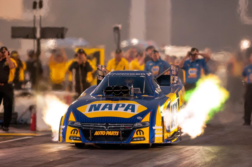 A drag racer's ride shoots flames as it screams down the track at the 2016 NHRA Sonoma Nationals at Sonoma Raceway. Photo by Mike Finnegan.
