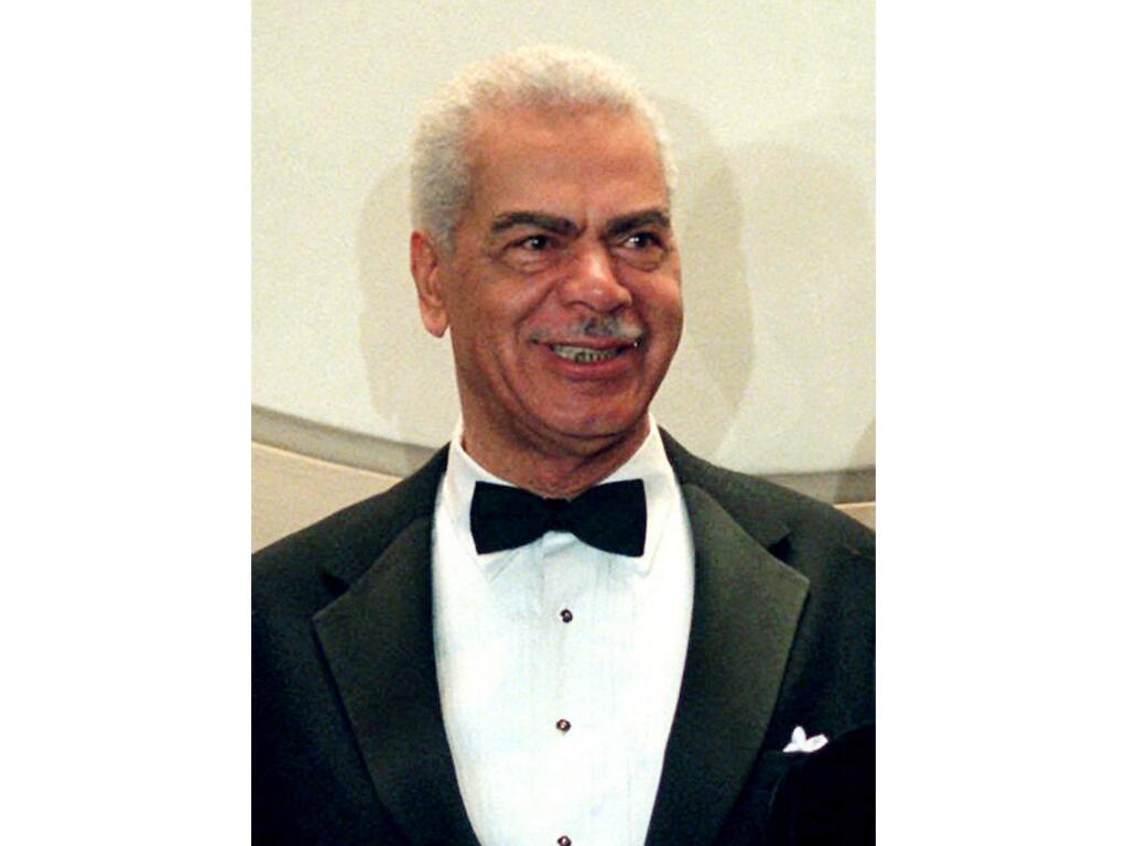 FILE - In this Feb. 3, 1997, file photo, Earle Hyman poses before an induction to the Theater Hall of Fame at the Gershwin Theatre in New York. Hyman, a veteran actor of stage and screen who was widely known for playing Russell Huxtable on 'The Cosby Show,' has died. Strohl, a representative for The Actors Fund, says that Hyman died Friday, Nov. 17, 2017, at the Lillian Booth Actors Home in Englewood, New Jersey. He was 91. (AP Photo/Ron Frehm, File)