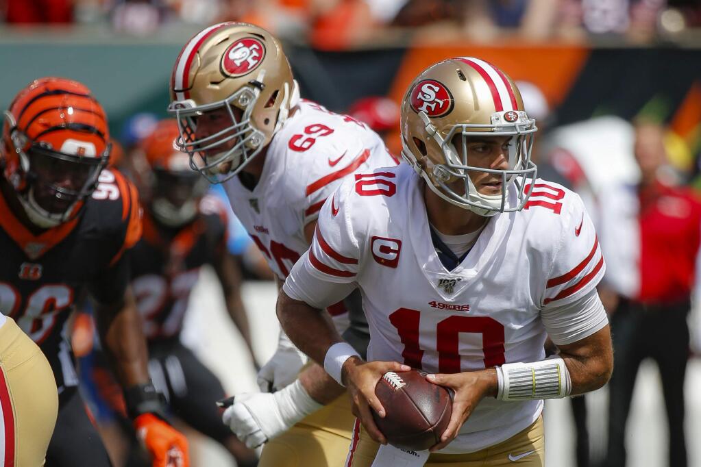 San Francisco 49ers quarterback Jimmy Garoppolo looks to hand off the ball during the first half against the Cincinnati Bengals, Sunday, Sept. 15, 2019, in Cincinnati. (AP Photo/Frank Victores)