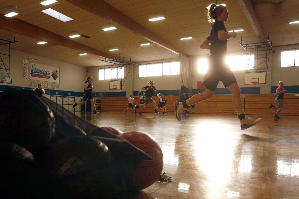 Rincon Valley Christian forwards Caroline Chambers, right, and Kylie Olson, far right, sprint with their teammates between honing their free throws during girls varsity basketball team practice at Rincon Valley Christian School in Santa Rosa, California on Tuesday, March 7, 2017. (Alvin Jornada / The Press Democrat)