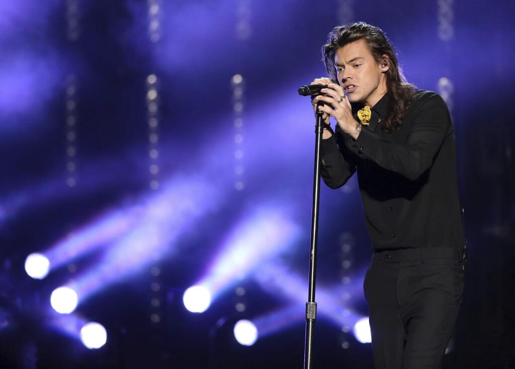 FILE - In this Nov. 22, 2015, file photo, Harry Styles of One Direction performs at the American Music Awards at the Microsoft Theater in Los Angeles. Styles announced a solo world tour on April 28, 2017, ahead of the May 12 release of his self-titled solo debut. (Photo by Matt Sayles/Invision/AP, File)