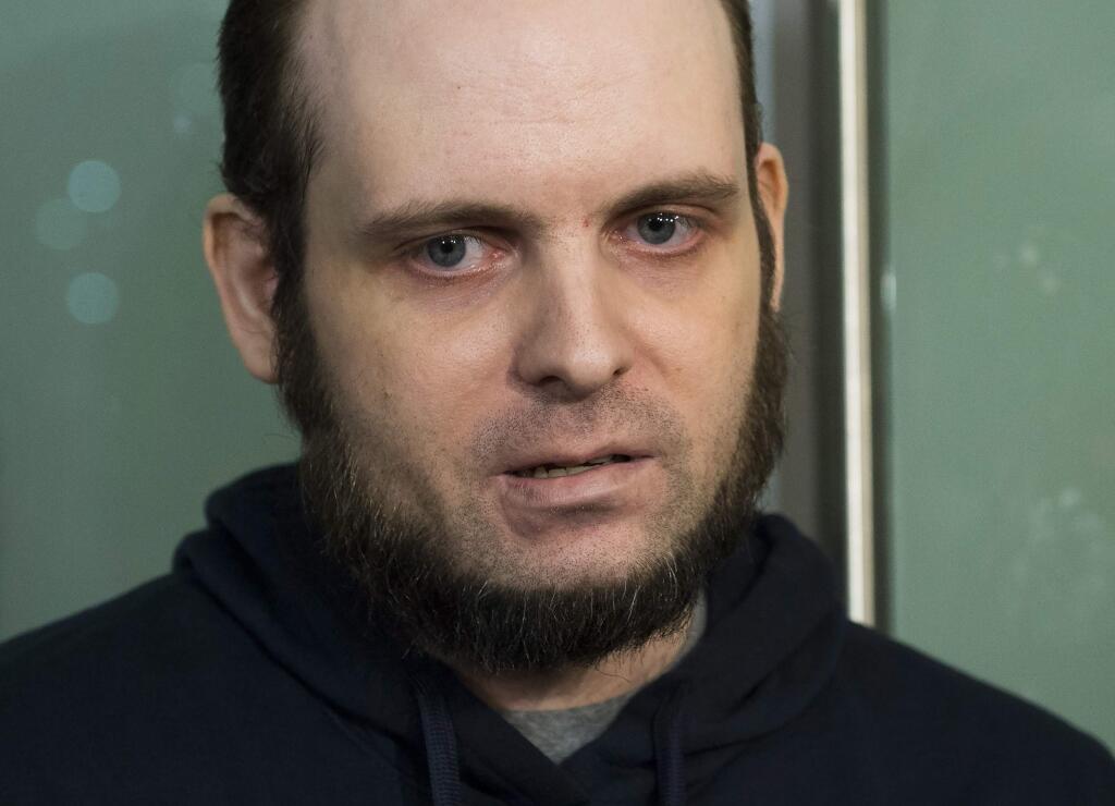 FILE- In this Oct. 31, 2017, file photo, Joshua Boyle speaks to the media after arriving at the Pearson International Airport in Toronto. A lawyer for Boyle, a Canadian man recently freed with his American wife and children after years of being held hostage in Afghanistan, says his client has been arrested and faces at least a dozen charges including sexual assault.Attorney Eric Granger said Tuesday, Jan. 2, 2017, that Boyle also faces assault and forcible confinement charges. (Nathan Denette/The Canadian Press via AP)