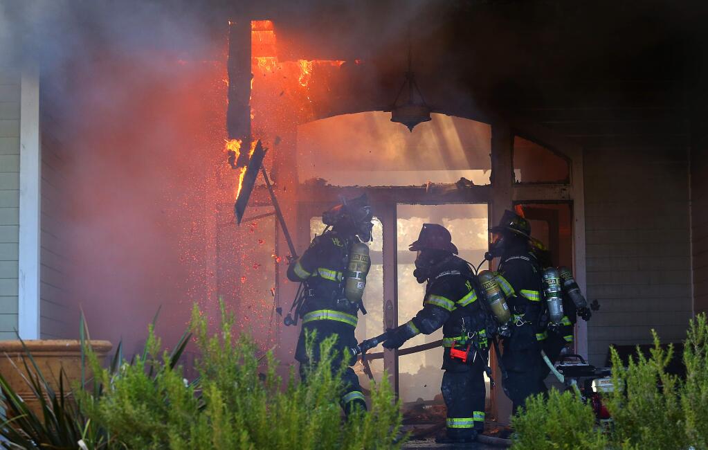 Firefighters from multiple agencies fight a structure fire on Turnberry Court, in Windsor, on Wednesday, June 24, 2015. (Christopher Chung/ The Press Democrat)