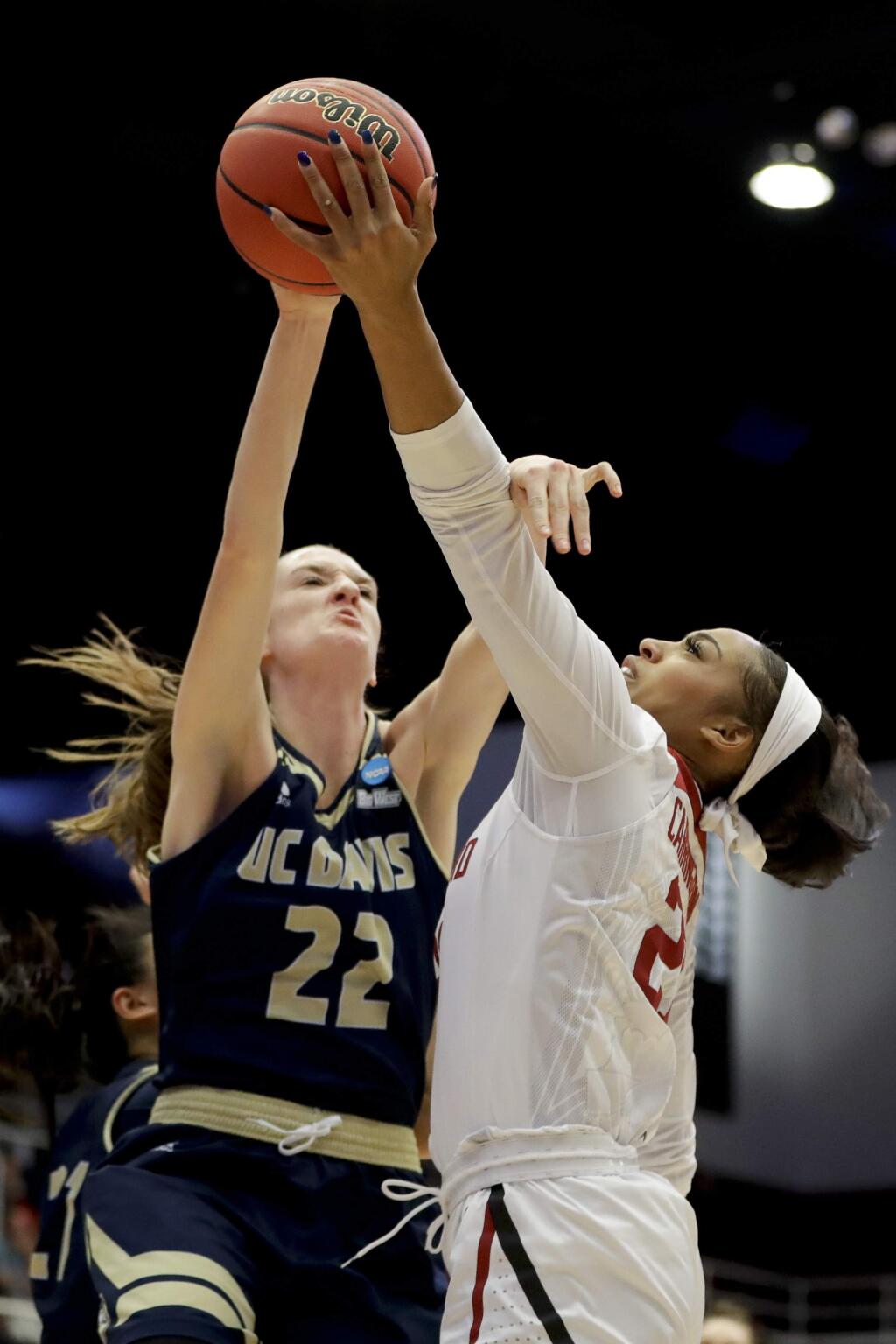UC Davis forward Morgan Bertsch, let, blocks a shot by Stanford guard Kiana Williams during the first half of a first-round game in the NCAA women's college basketball tournament in Stanford, Calif. Saturday, March 23, 2019. (AP Photo/Chris Carlson)