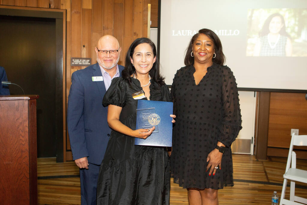 RCU Branch Experience manager Rene Maza, left, and NBBJ Publisher Lorez Bailey, right, award Laura Alamillo, Dean of SSU’s School of Education with the 2022 Latino Business Leadership Award on Oct. 20, 2022, at the DeTurk Round Barn in Santa Rosa. (Charlie Gesell photo)