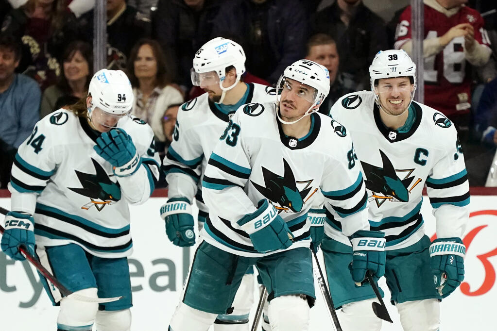 San Jose Sharks left wing Matt Nieto (83), who scored against the Arizona Coyotes, skates back to the bench with left wing Alexander Barabanov (94), defenseman Erik Karlsson (65) and center Logan Couture (39) during the third period Tuesday in Tempe, Arizona. (Ross D. Franklin / ASSOCIATED PRESS)