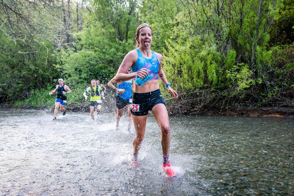 Runner Keely Henninger crosses a creek in the Lake Sonoma 50 race. (Howie Stern)