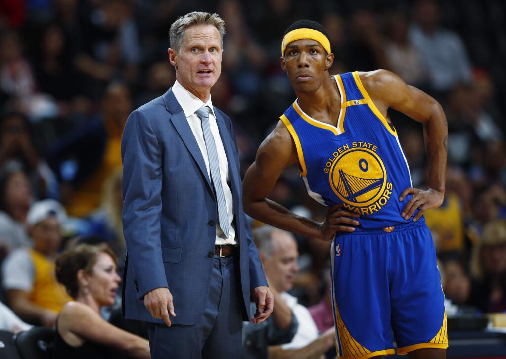 Golden State Warriors coach Steve Kerr, left, confers with guard Patrick McCaw in overtime of an NBA preseason basketball game against the Denver Nuggets on Friday, Oct. 14, 2016, in Denver. The Warriors won 129-128 in overtime. (AP Photo/David Zalubowski)