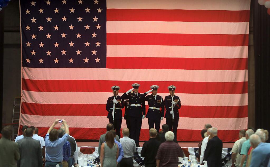 The color guard from the Two Rock Coast Guard base salute the colors during the 17th Annual Tribute to our Veterans luncheon, Thursday, Nov. 9, 2018 at the Santa Rosa Veterans Memorial Building in Santa Rosa. (Kent Porter / The Press Democrat) 2018