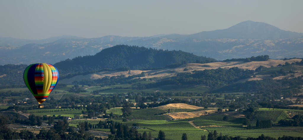 Geyser Peak and vineyards north of Windsor serve as a backdrop for the Sonoma County Hot Air Balloon Classic in Windsor, Friday, June 8, 2018. (Kent Porter / The Press Democrat, 2018)