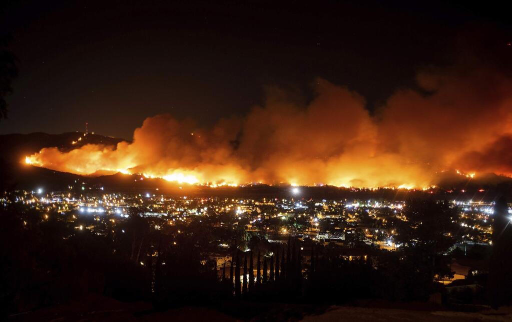 FILE - In this Oct. 31, 2019, file photo, smoke from the Maria fire billows above Santa Paula, Calif. (AP Photo/Noah Berger, File)