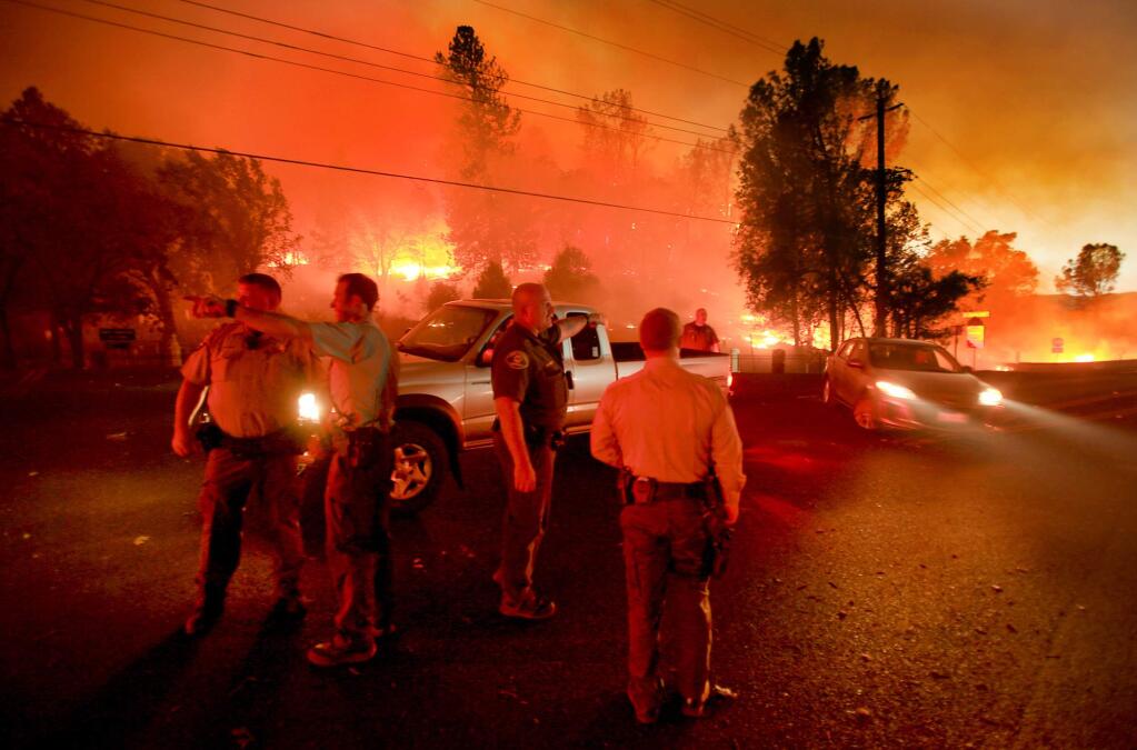 Lake County sheriff's officers evacuate Highway 29 at Butts Canyon Road in Middletown as the Valley fire jumps the highway, Saturday Sept. 12, 2015. (Kent Porter / Press Democrat) 2015