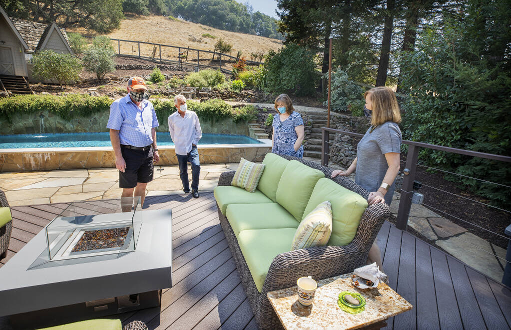 From right, real estate agent Tammra Borrall shows off the backyard of an east Santa Rosa home to Patty and Mark Bowers and their agent, Ed Heinz, on Thursday, Aug. 20, 2020. (John Burgess / The Press Democrat)