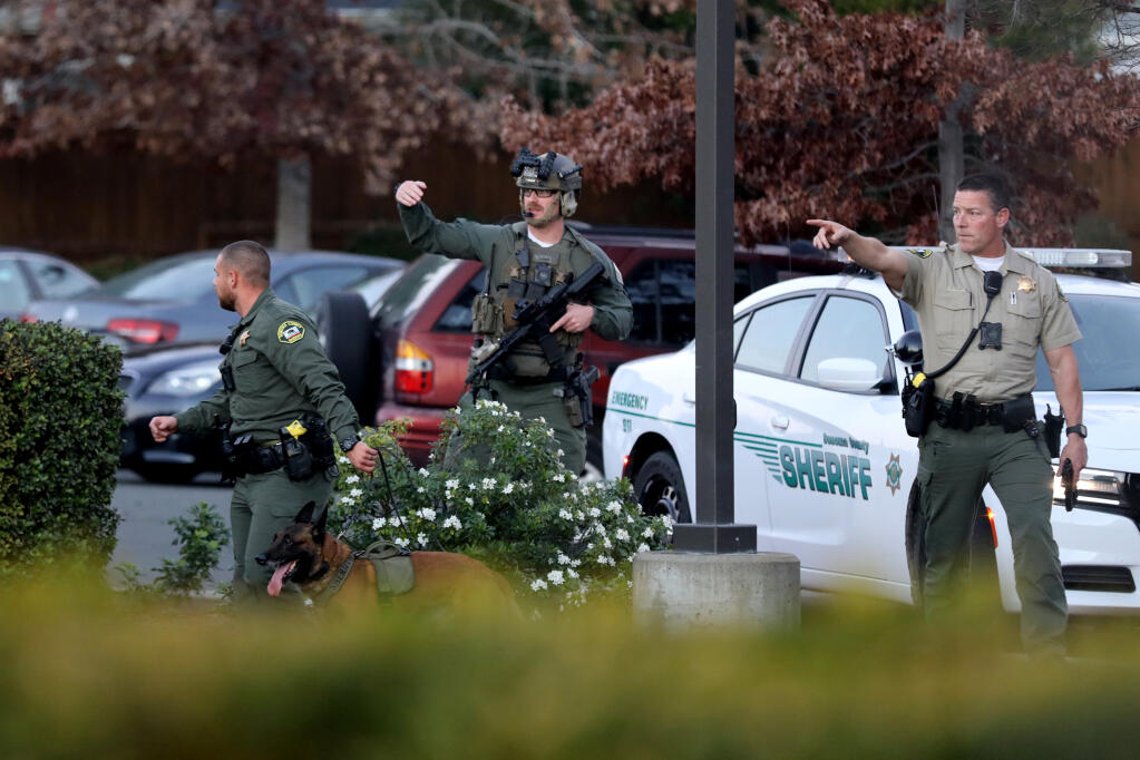 Sonoma County Sheriff's deputies search for armed robbery suspects along Lindberg Circle in Petaluma, Calif., on Sunday, November 28, 2021.(Beth Schlanker/The Press Democrat)