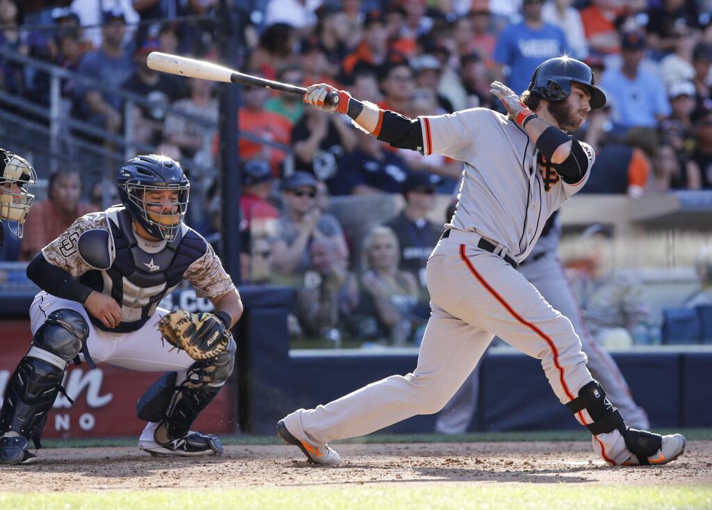San Francisco Giants' Brandon Crawford strikes out swinging the end the baseball game against the San Diego Padres, who won 8-2 on Sunday, Sept. 21, 2014, in San Diego. (AP Photo/Don Boomer)