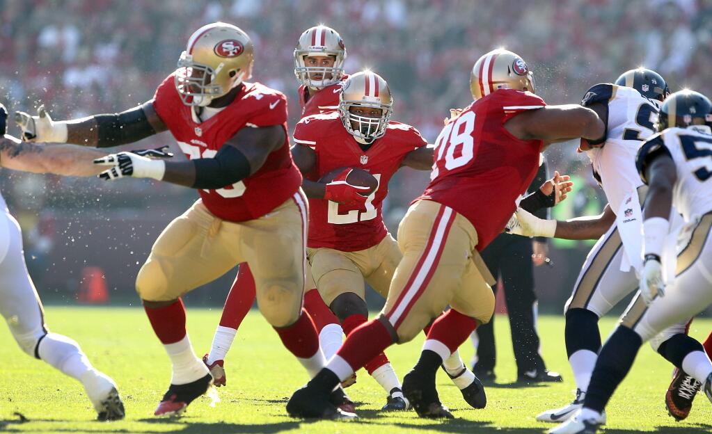 Joe Looney, #78 on right, could be a contender for right guard if Joe Looney's contract isn't renewed. In this 2013 file photo, Frank Gore waits for Anthony Davis, left, and Joe Looney to open a hole against the Rams defense. (John Burgess/The Press Democrat)