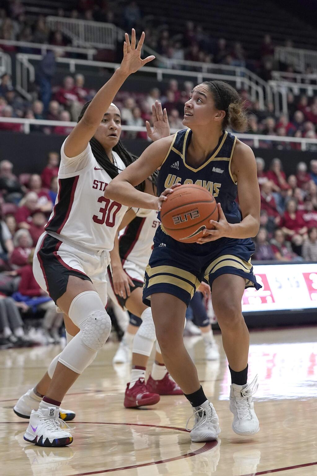 UC Davis forward Cierra Hall, right, looks to shoot against Stanford guard Haley Jones (30) during the second half, aturday, Dec. 28, 2019, in Stanford. (AP Photo/Tony Avelar)