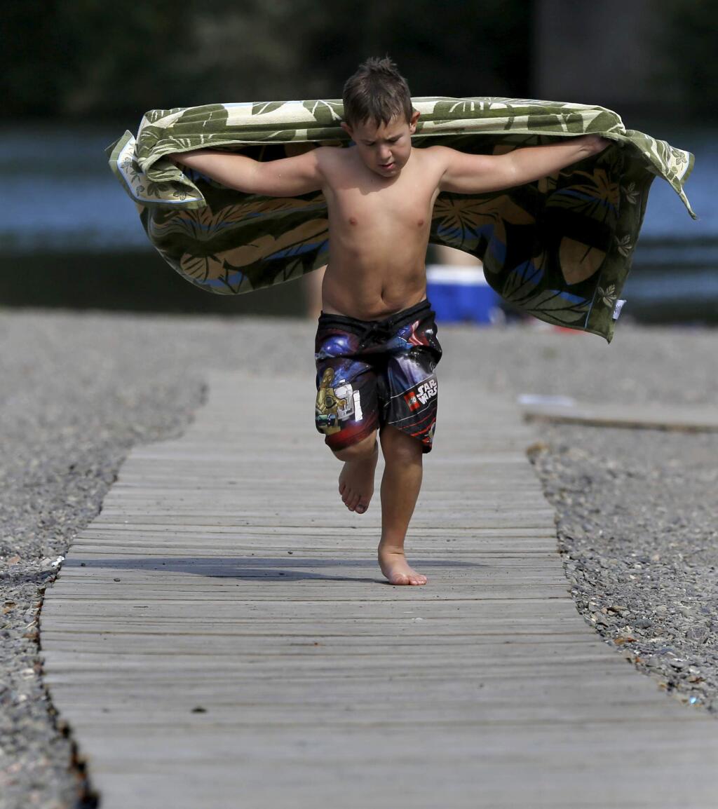 Jackson Styx, 8, runs along the boardwalk at Johnson's Beach on Sunday, Sept. 28, 2014. (BETH SCHLANKER / The Press Democrat)