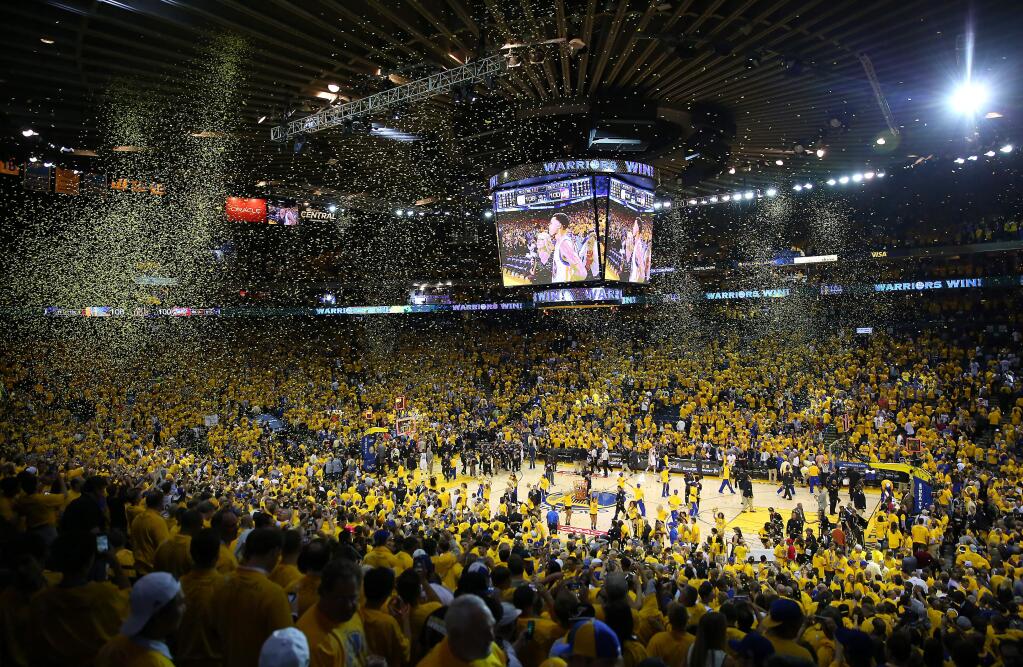 Confetti falls from the rafters at the end of overtime of Game 1 of the NBA Finals at Oracle Arena in Oakland on Thursday, June 4, 2015. The Warriors defeated the Cavaliers 108-100 in overtime. (Christopher Chung / The Press Democrat)