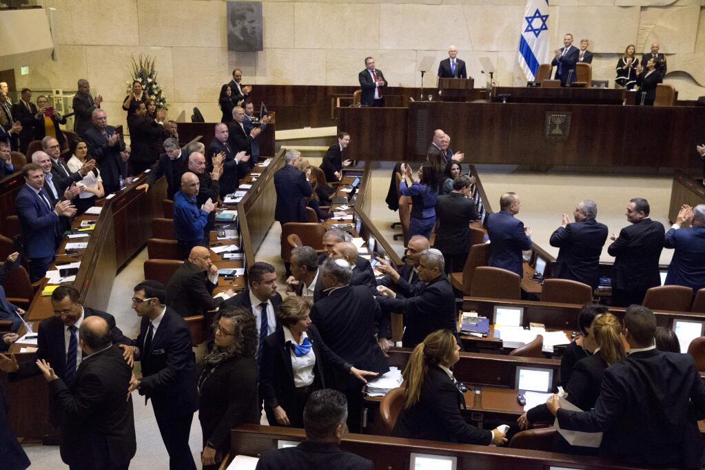 Israeli Arab members are escorted by security out as U.S. Vice President Mike Pence speaks in Israel's parliament in Jerusalem, Monday, Jan. 22, 2018. (AP Photo/Ariel Schalit, Pool)
