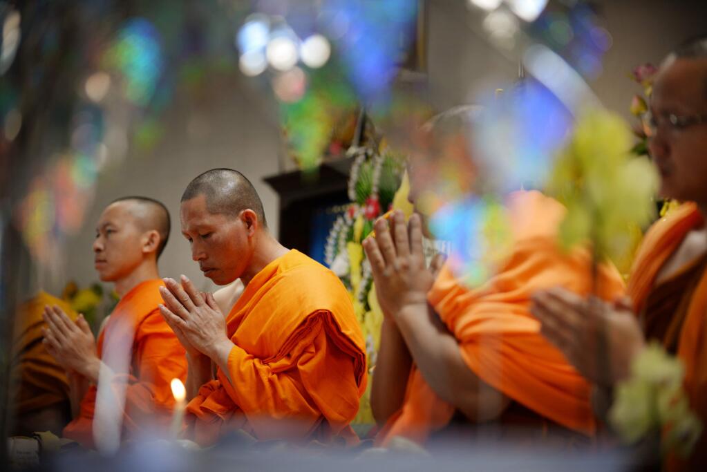 Buddhist monks during prayer service at the start of the Lao New Year festival held Sunday at Wat Lao Saysettha the Theravada Buddhist center in Santa Rosa. April 30, 2017. (Photo: Erik Castro/for The Press Democrat)