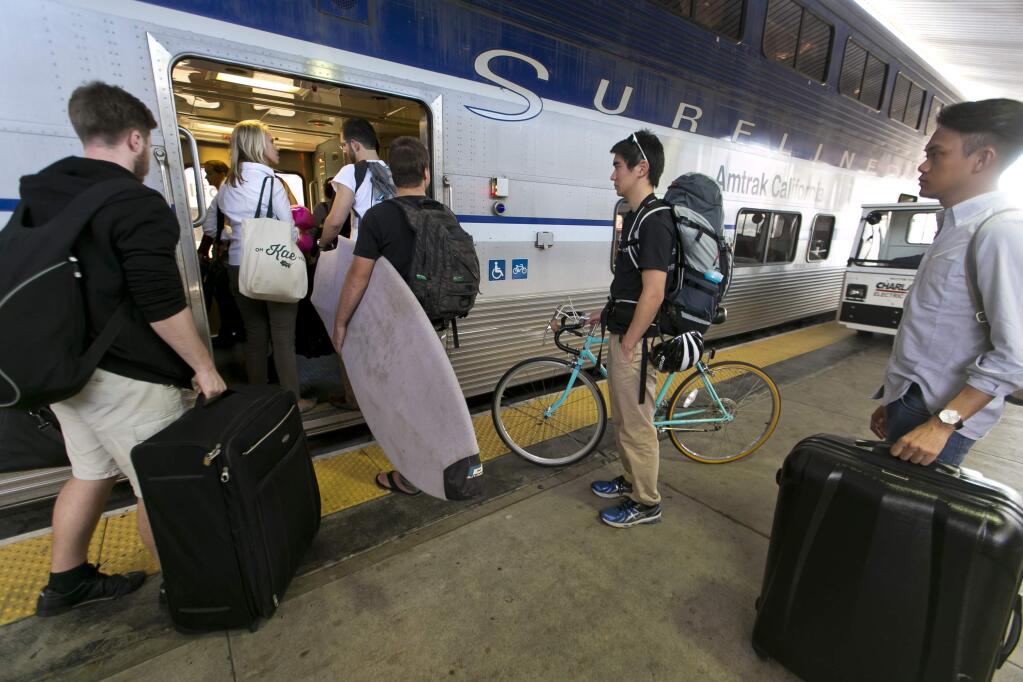 Passengers board an Amtrak Surfliner train bound to Santa Barbara at Union Station in Los Angeles on Nov. 26, 2014, a day before Thanksgiving. (DAMIAN DOVARGANES / Associated Press, 2014)