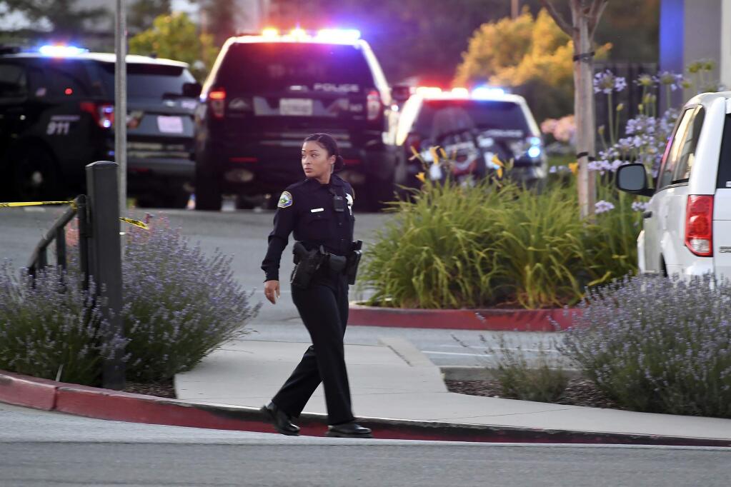 Police investigate at the scene of a shooting at the Ford Store Morgan Hill in Morgan Hill, Calif., Tuesday, June 25, 2019. Police say the shooting has killed at least two people in what may be a workplace confrontation. (AP Photo/Nic Coury)
