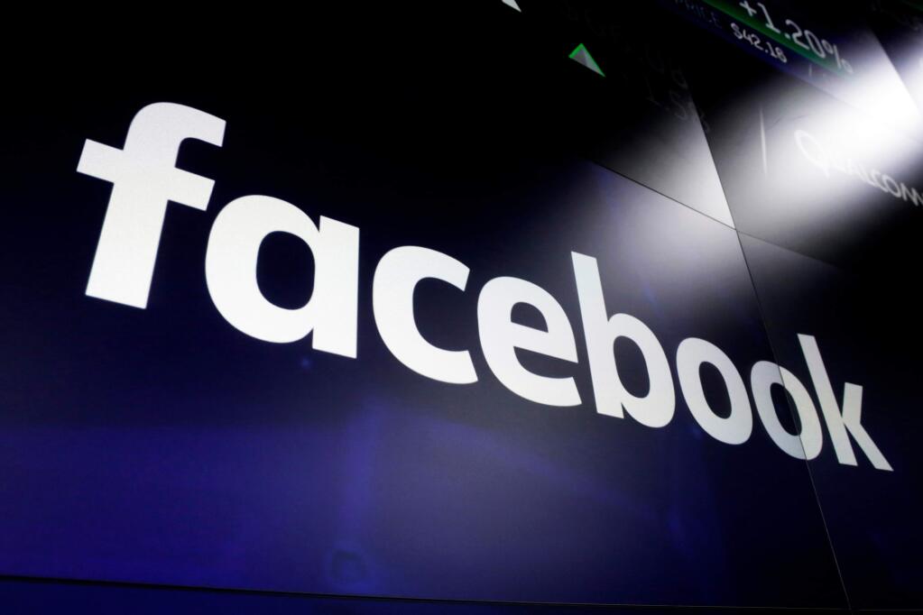 FILE - This March 29, 2018 file photo, shows logo for social media giant Facebook at the Nasdaq MarketSite in New York's Times Square. (AP Photo/Richard Drew, File)