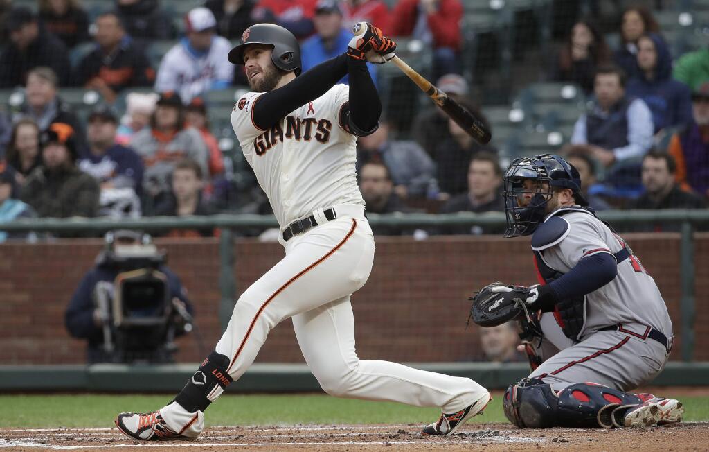 The San Francisco Giants' Evan Longoria watches his RBI double in front of Atlanta Braves catcher Brian McCann during the first inning in San Francisco, Tuesday, May 21, 2019. (AP Photo/Jeff Chiu)