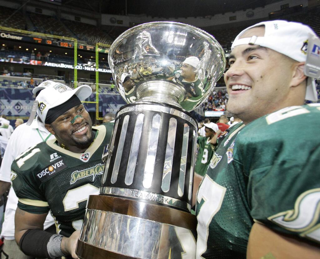 San Jose SaberCats football players Phil Glover left, and Brian Johnson hold the trophy after their win over the Columbus Destroyers in Arena Bowl XXI in New Orleans, Sunday, July 29, 2007. The SaberCats won 55-33. (AP Photo/Alex Brandon)