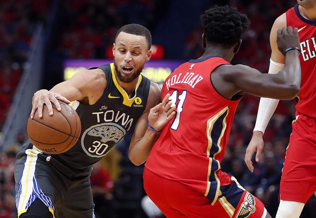 Golden State Warriors guard Stephen Curry (30) tries to dribble around New Orleans Pelicans guard Jrue Holiday (11) in the first half of Game 4 of a second-round NBA basketball playoff series in New Orleans, Sunday, May 6, 2018. (AP Photo/Gerald Herbert)