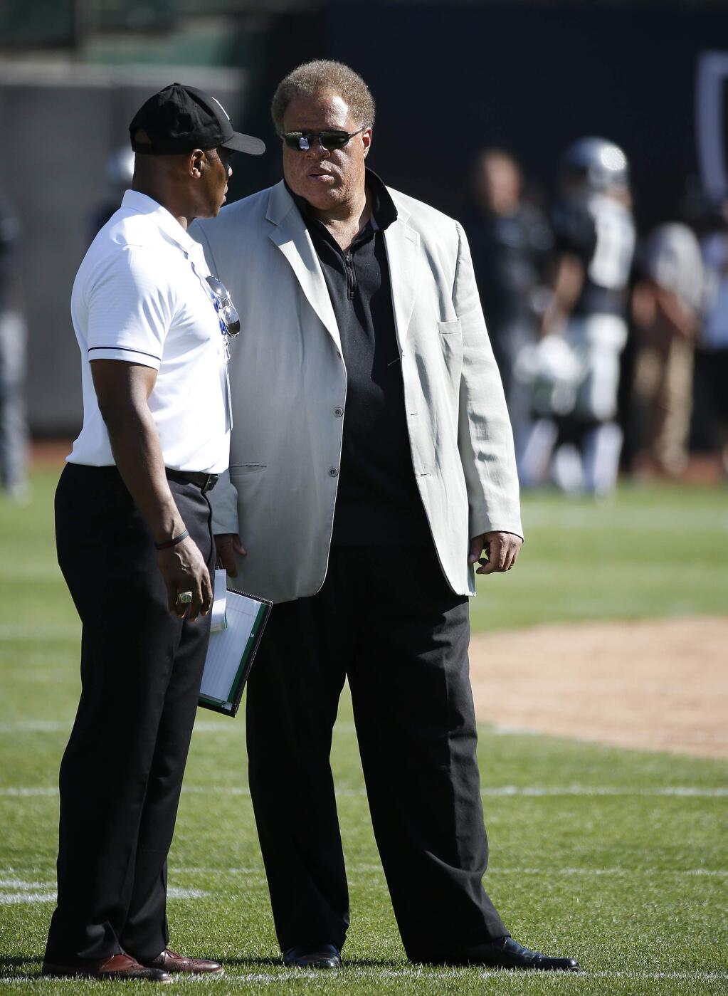 Oakland Raiders general manager Reggie McKenzie, right, stands on the sidelines before the start of a game against the Tennessee Titans Saturday, Aug. 27, 2016, in Oakland. (AP Photo/Tony Avelar)